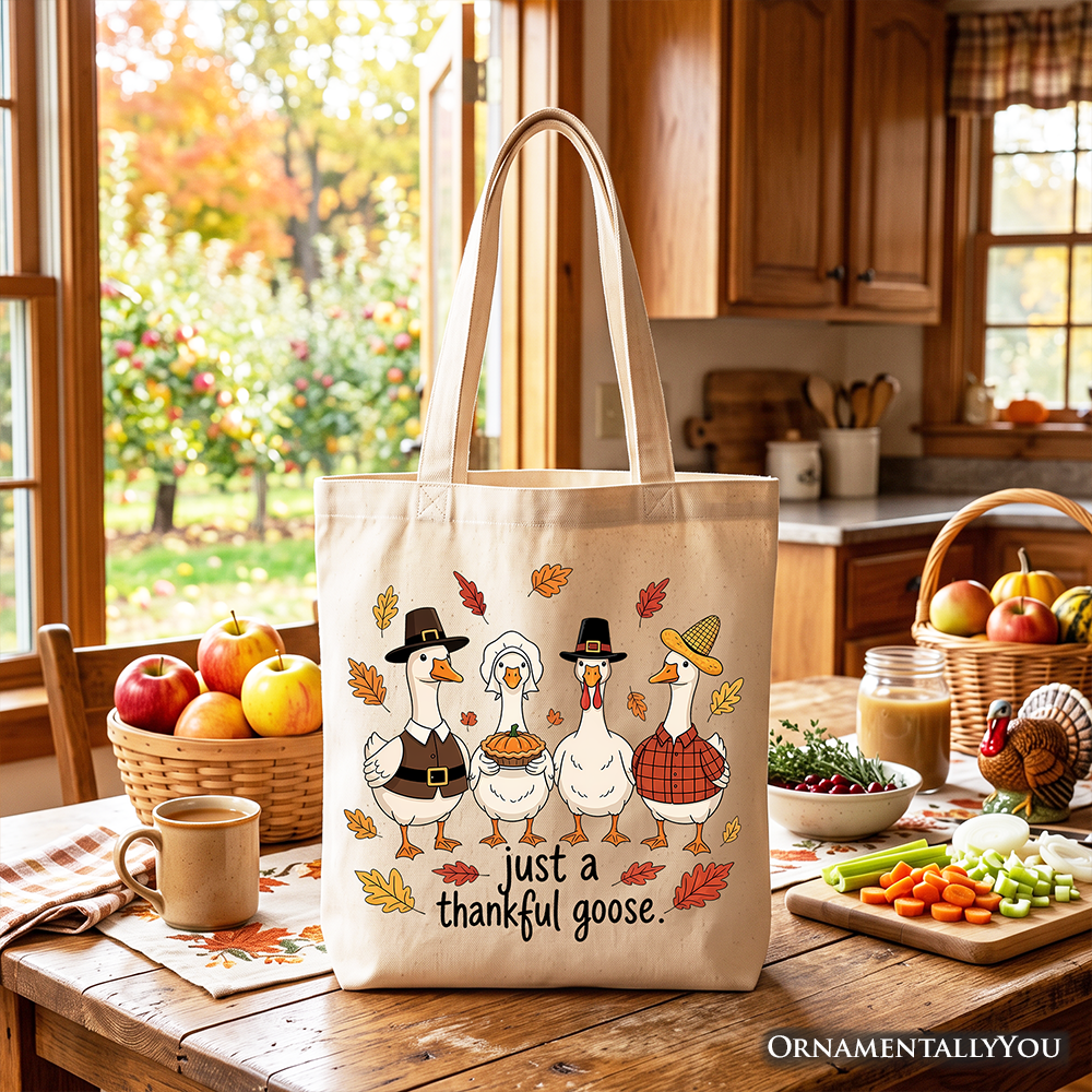 White canvas tote bag with beige handles and turkey family illustration reading 'just a thankful goose'