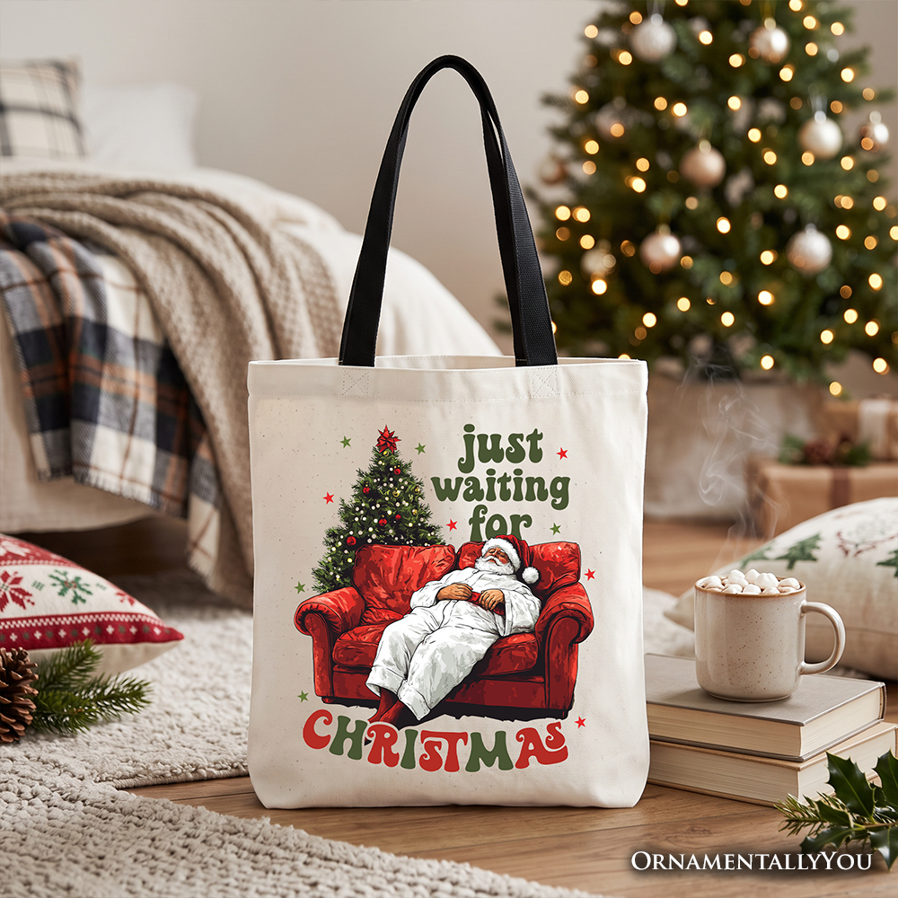 Cream tote bag with Santa-on-couch 'Just waiting for Christmas' print, black handles