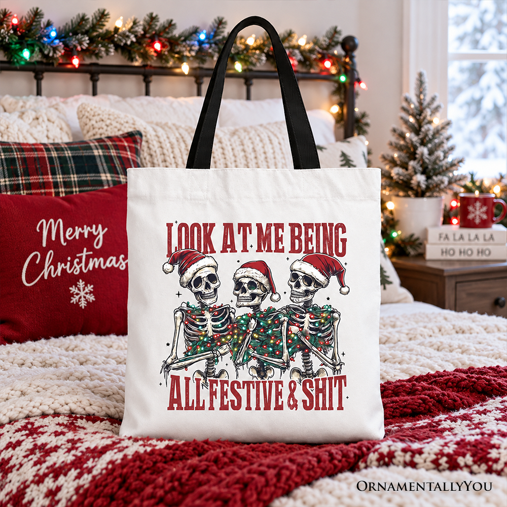 White cotton tote bag with skeleton holiday graphic and red text; black handles