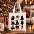 White tote bag featuring a grid of black cats wearing Santa hats and holiday outfits