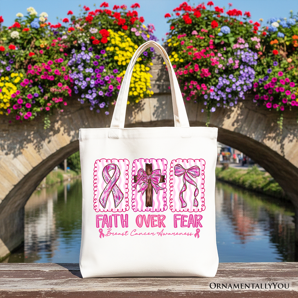 White tote bag with pink ribbon 'Faith Over Fear' and bow detail graphic