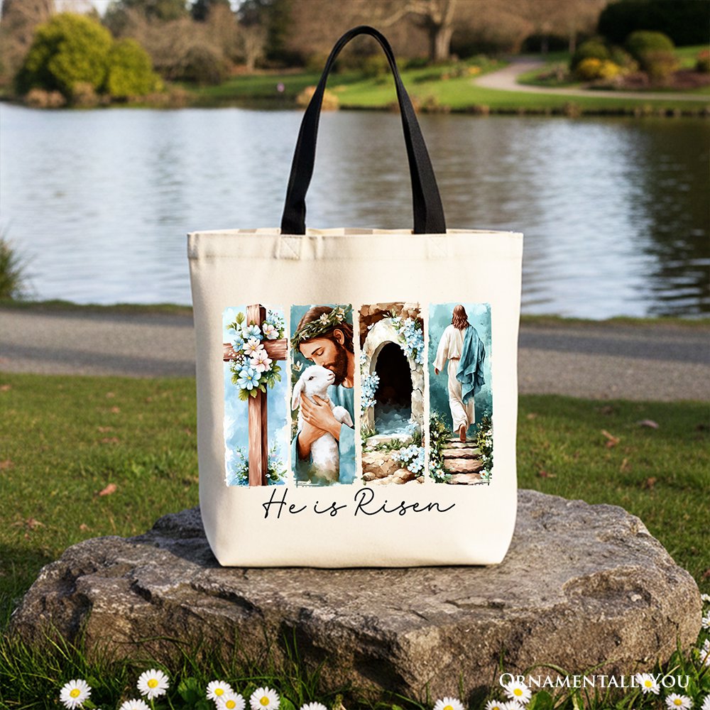 White canvas tote bag with floral arch collage and "He Is Risen" script on front.