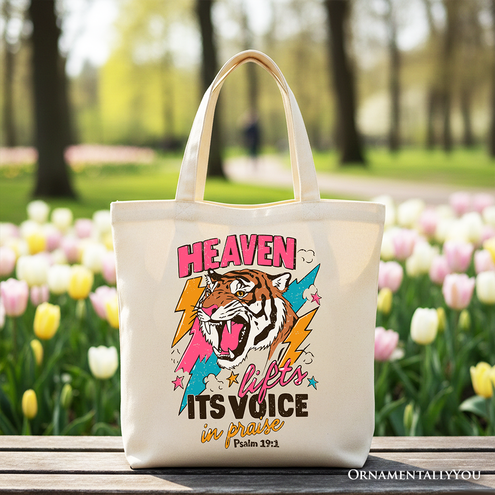 Cream tote bag with tiger graphic and “Its voice in praise” text on the front.