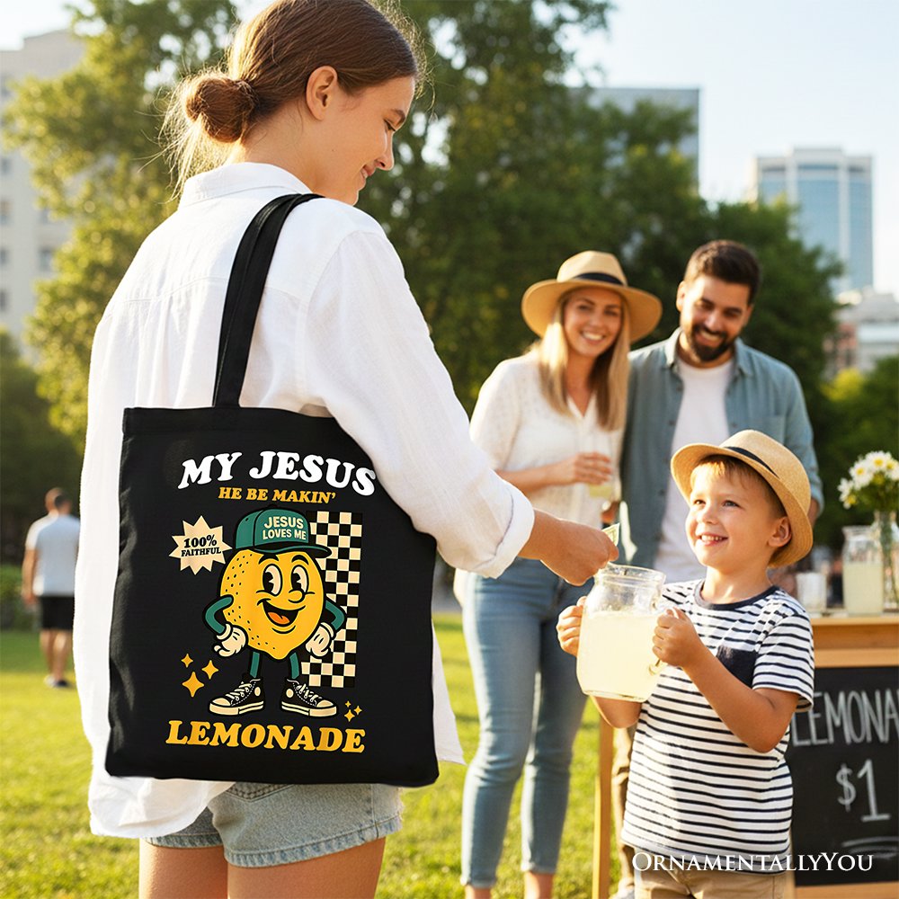 Black tote bag with 'My Jesus' lemonade cartoon graphic and top handles.