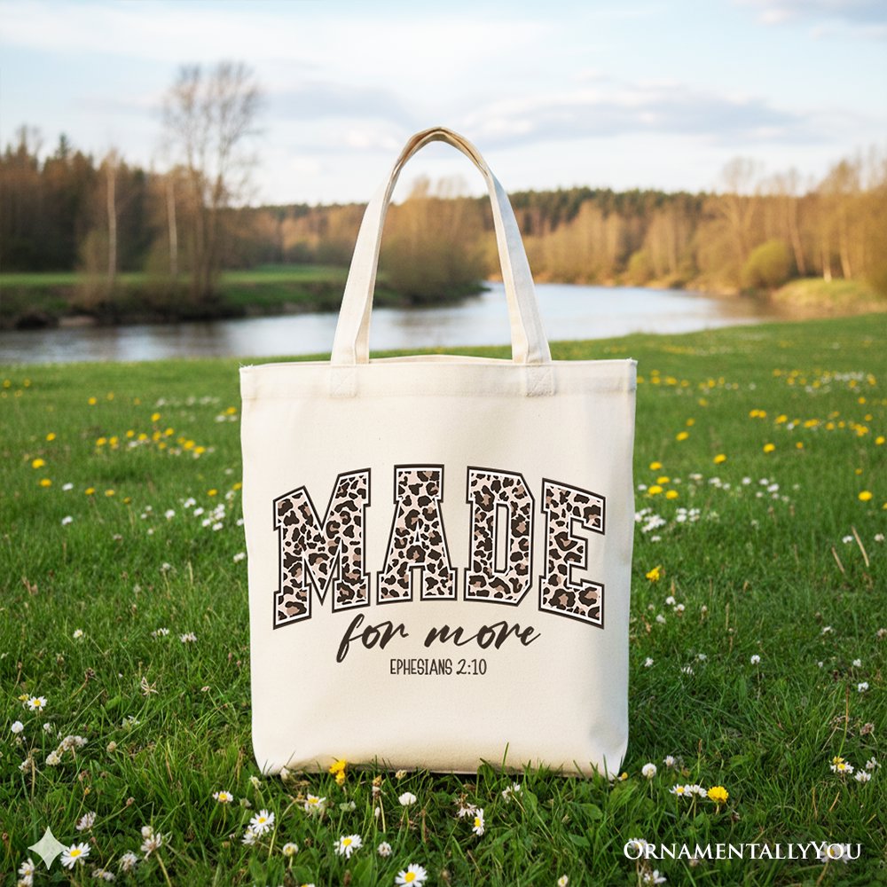 White canvas tote bag with black leopard-style "MADE for more" text and handles