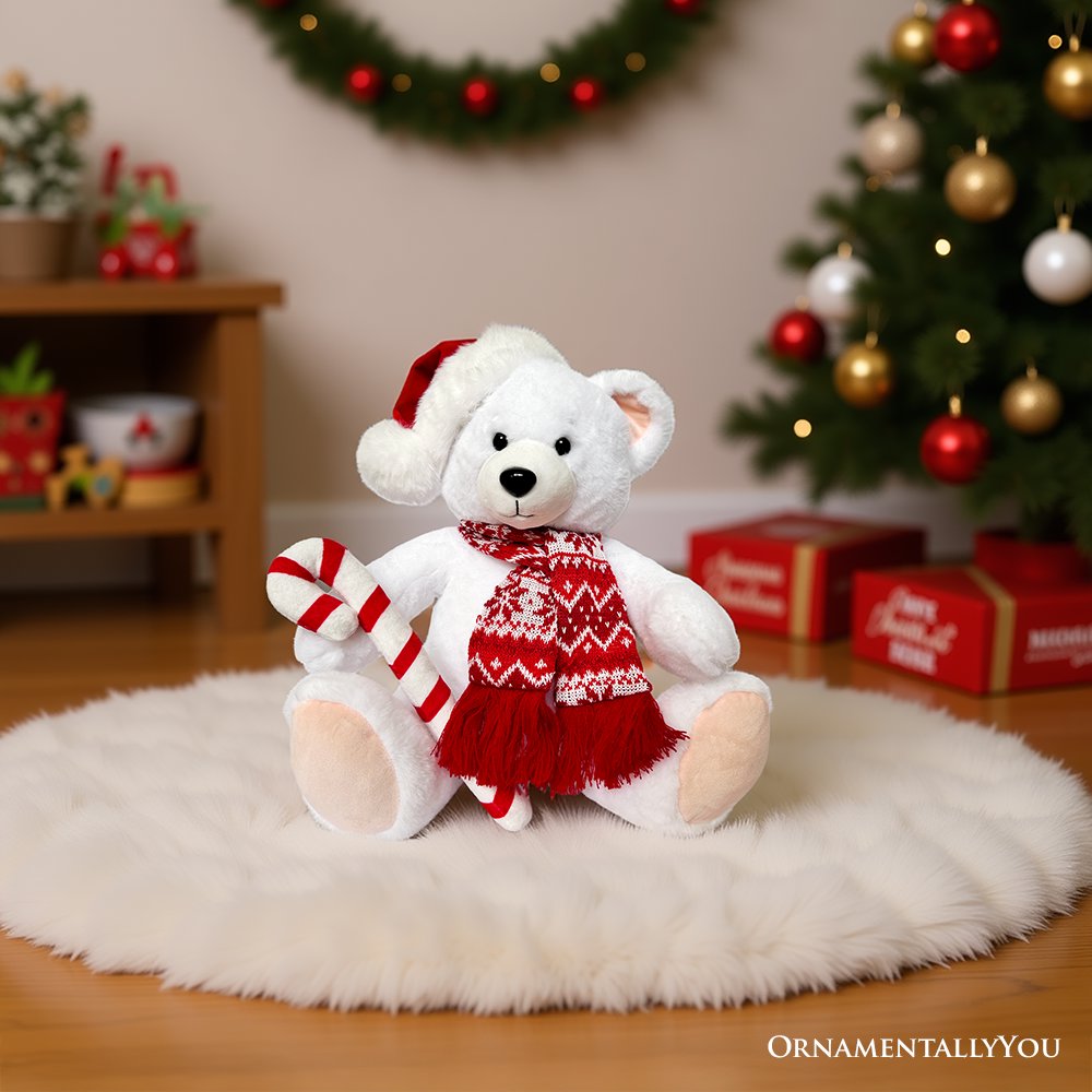 White polar bear plush in red patterned sweater with striped candy cane, seated on white rug