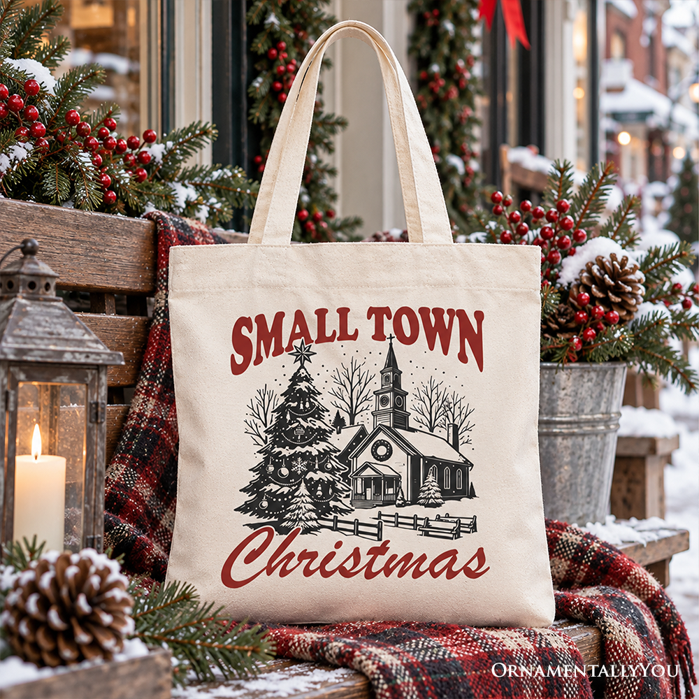 Cream Christmas tote bag with “Small Town Christmas” church, tree, and fence graphic