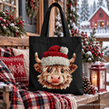 Black canvas tote bag featuring Highland cow face in red-and-white Santa hat