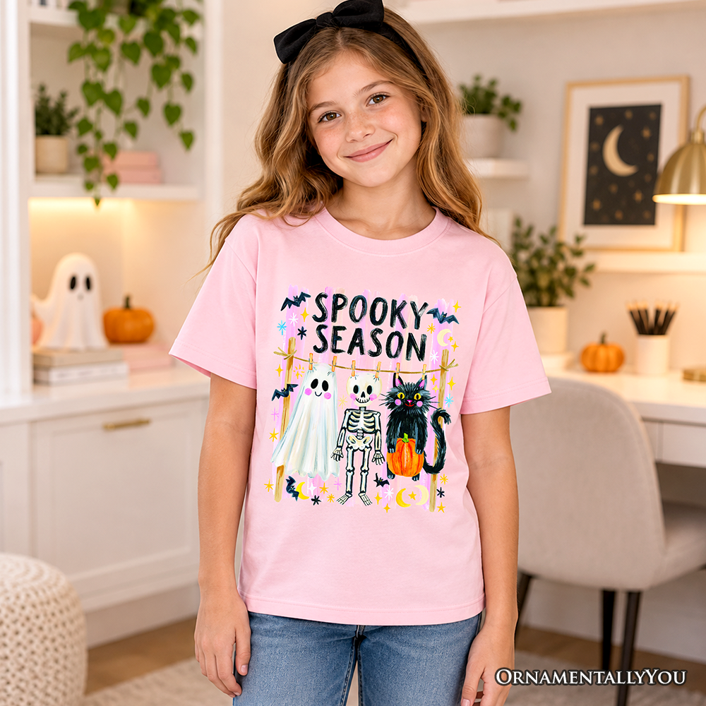 Kids light pink spooky season graphic T-shirt with colorful haunted character artwork