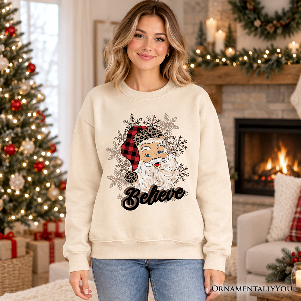 Beige crewneck sweatshirt with Santa face, snowflakes, and 'Believe' print