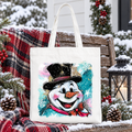 White cotton tote bag with navy handles and glitter-style snowman portrait print