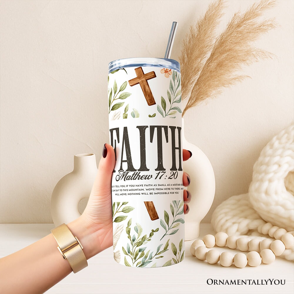 Faith tumbler in hand with lid and stainless straw; white leaf, dove, and cross design