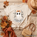 White kids T-shirt flat lay with ghost graphic, orange bow, short sleeves