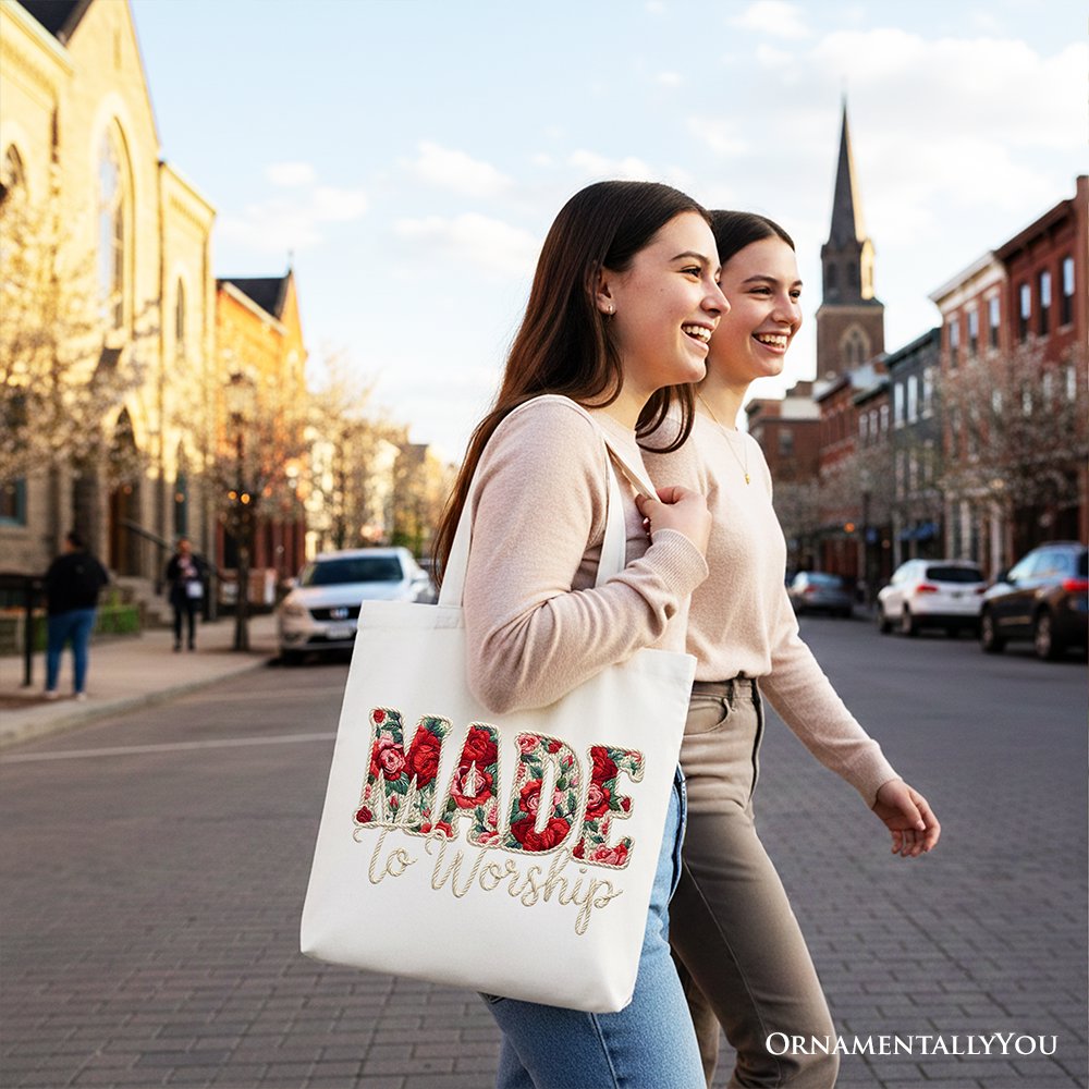 White tote bag with floral “MADE to Worship” print, carried by a shopper