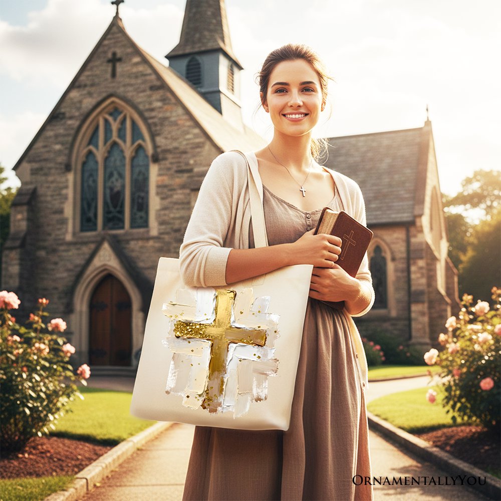 White canvas tote bag with gold cross print, worn over shoulder