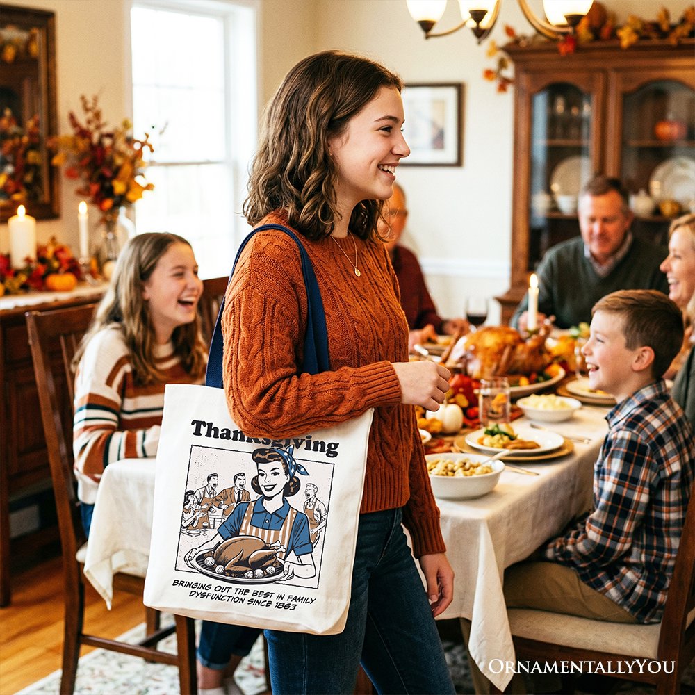 White tote bag with black handles, Thanksgiving artwork printed on the front for carrying.