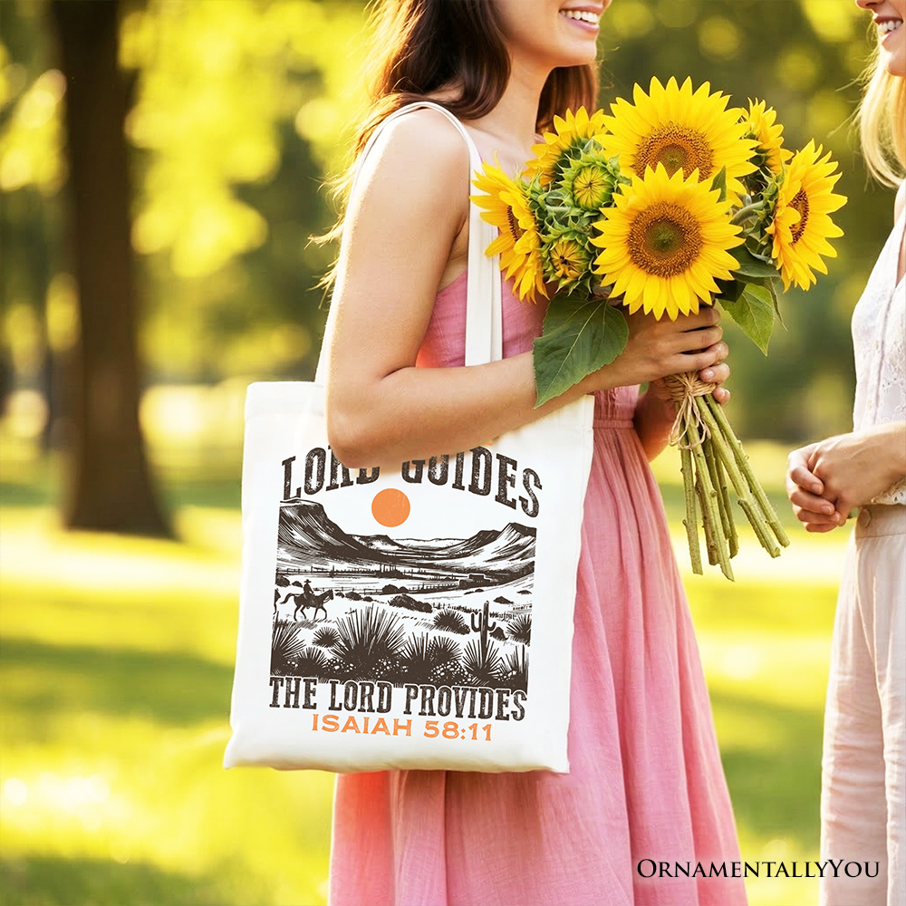 White tote bag with desert graphic and 'The Lord Provides' Isaiah 58:11, carried