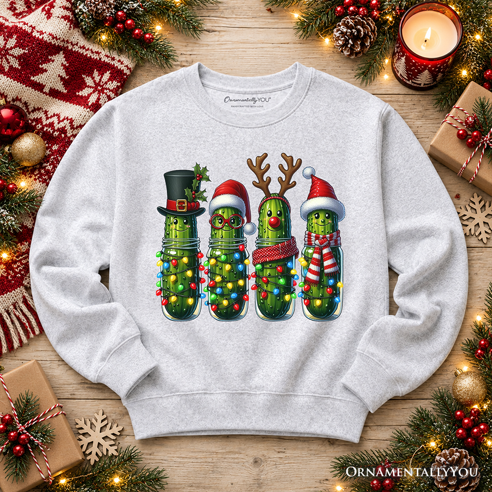 Ash crewneck sweatshirt laid flat, featuring festive pickle character graphic