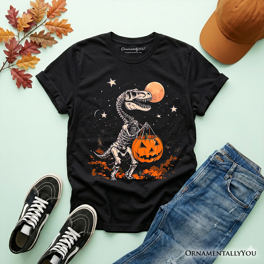 Black youth T-shirt laid flat with dinosaur skeleton, moon, stars, and pumpkin graphic