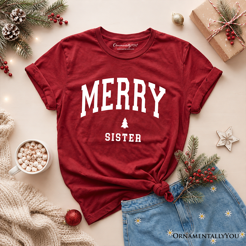 Kids red Christmas T-shirt flat lay with “MERRY SISTER” and tree graphic