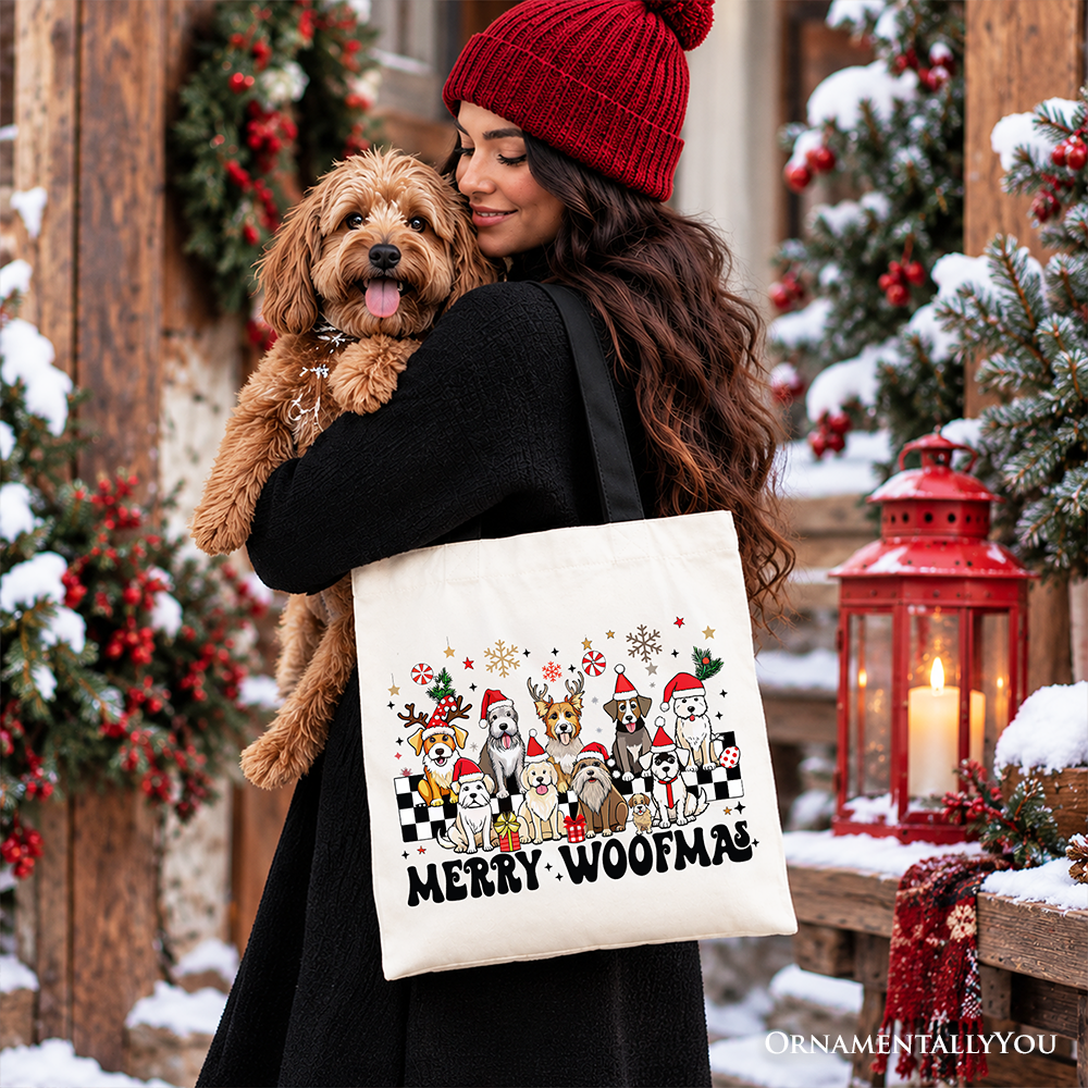Beige cotton tote bag with Merry Woofmas dog graphic hanging from shoulder