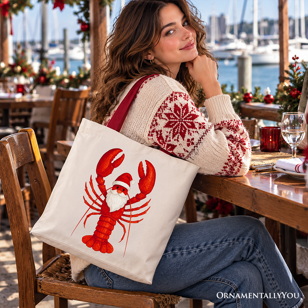White cotton tote bag with red lobster Santa print, carried on shoulder