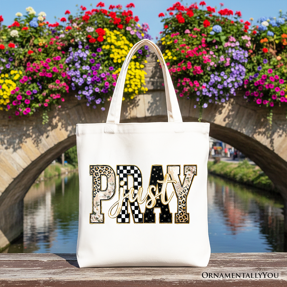 White tote bag with “Pray” patchwork graphic across the front