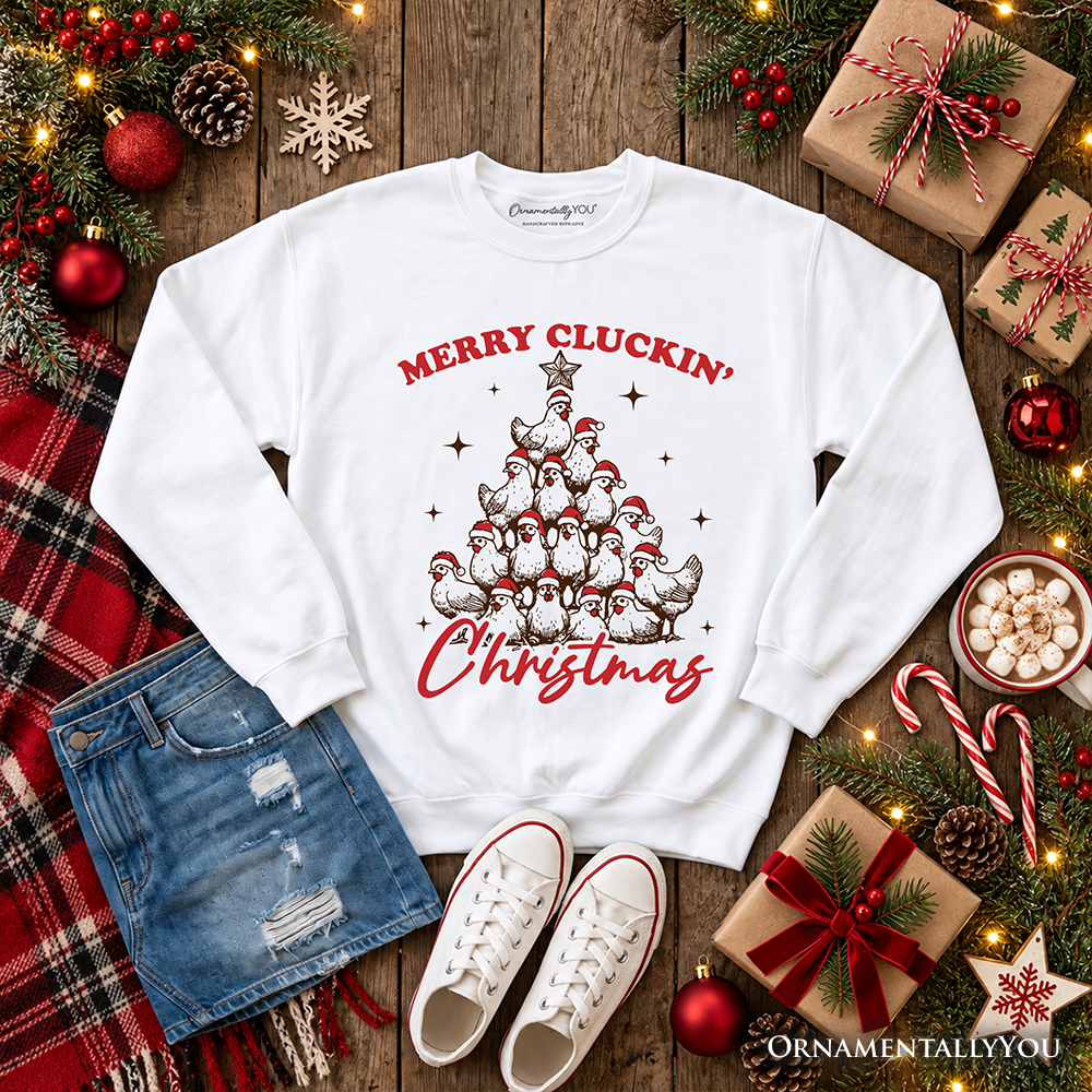 White long-sleeve crewneck sweatshirt with red "Merry Cluckin' Christmas" chicken tree graphic