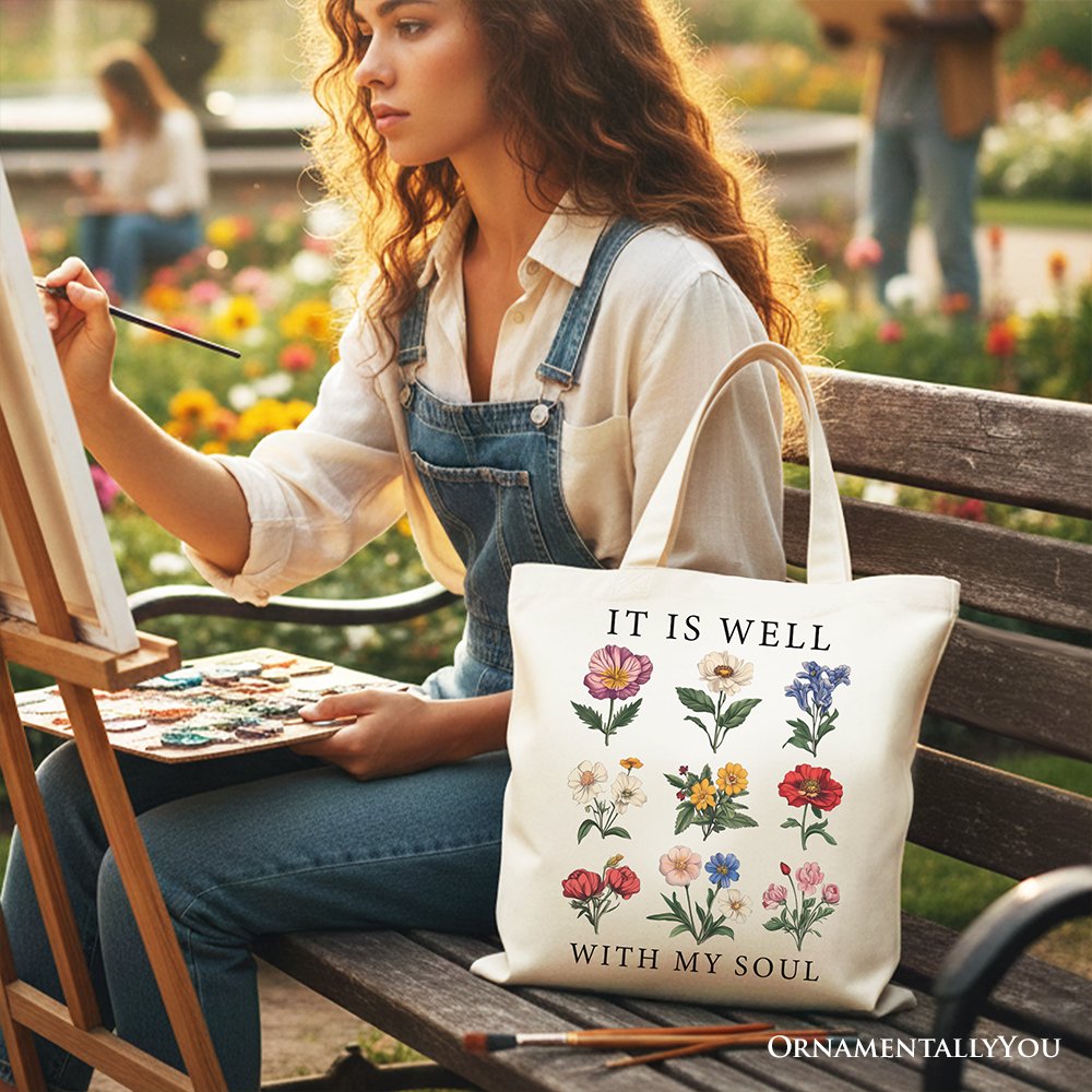 White canvas tote with long handles, multi-flower design with 'IT IS WELL' and 'WITH MY SOUL'.