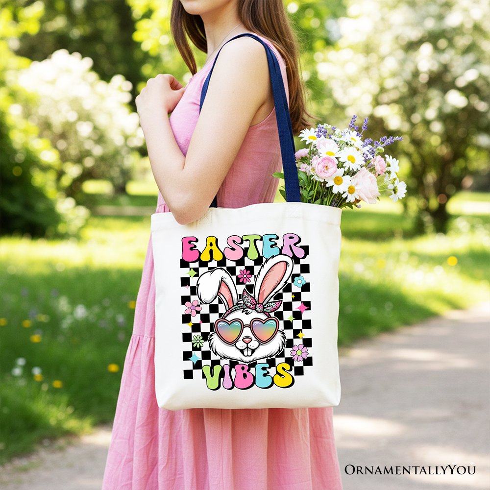 White tote bag with navy handles and 'Easter Vibes' bunny graphic.