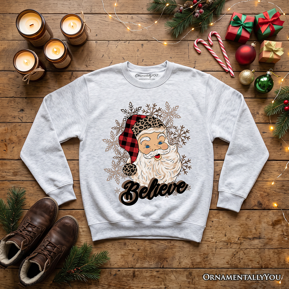 Light gray crewneck sweatshirt with Santa face, snowflakes, and 'Believe' print