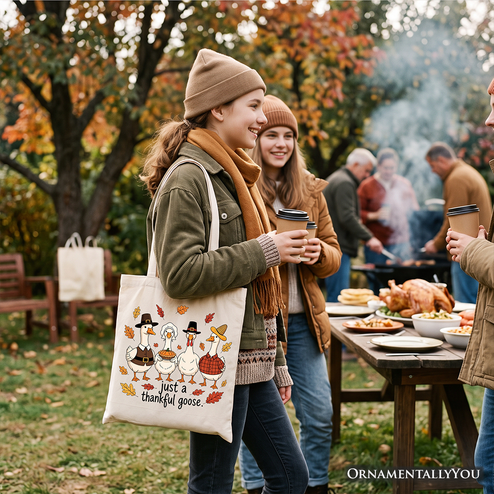 White tote bag with beige handles, Thanksgiving goose cartoon and 'just a thankful goose'
