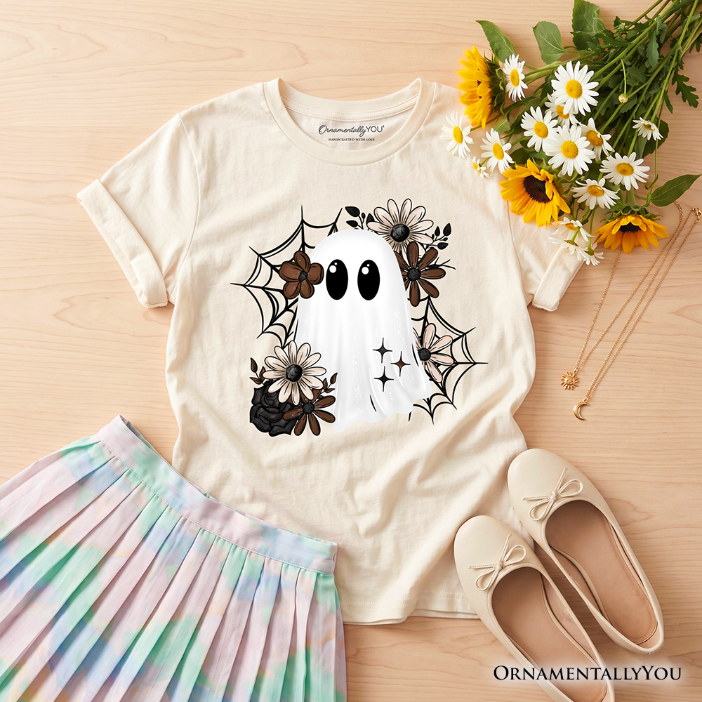 Kids cream T-shirt on wood background with ghost face, flowers, and spiderweb print