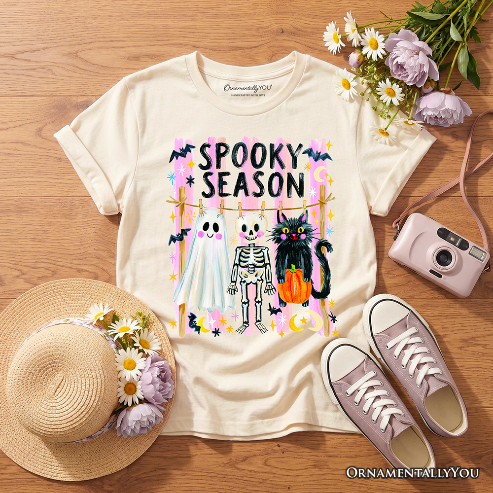 Cream kids spooky season graphic T-shirt laid flat with colorful haunted character print