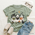 Kids sage green T-shirt with ghost characters, witch cat, moon, and book graphic