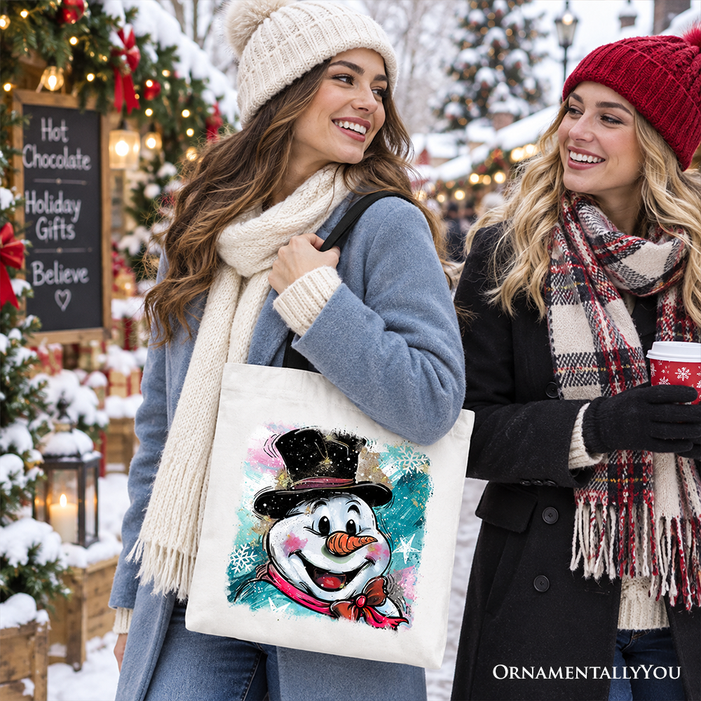 White cotton tote bag with navy handles, snowman graphic featuring teal and pink bursts