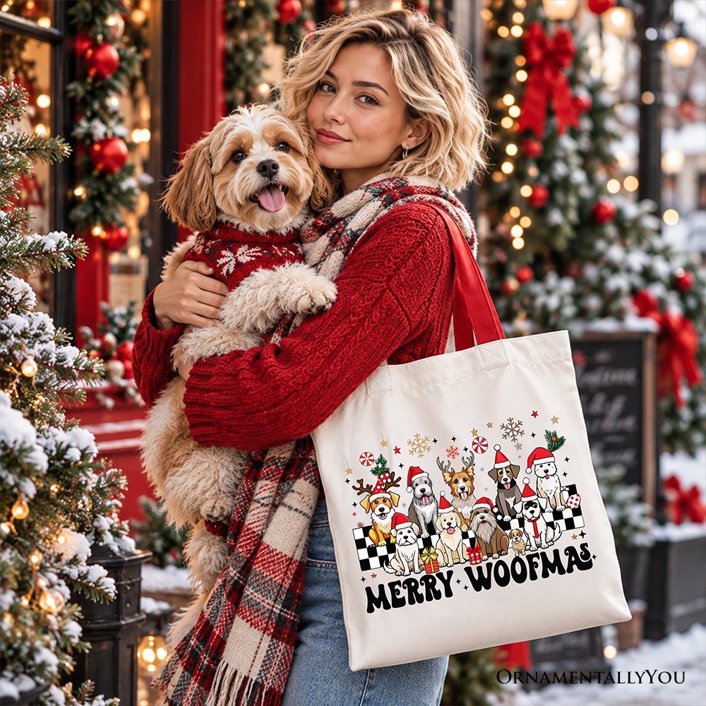 Beige cotton tote bag with Merry Woofmas dog graphic held in front of woman