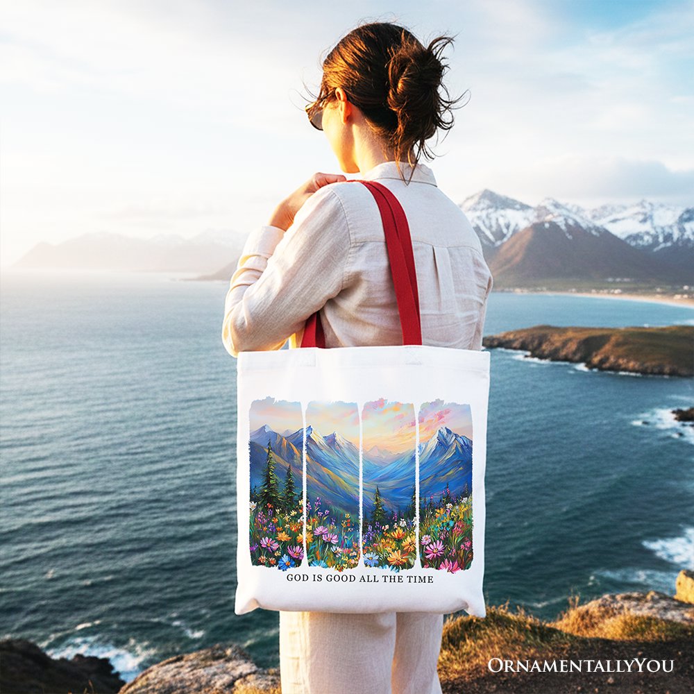 White canvas tote bag with red handles, mountain landscape bible verse print.