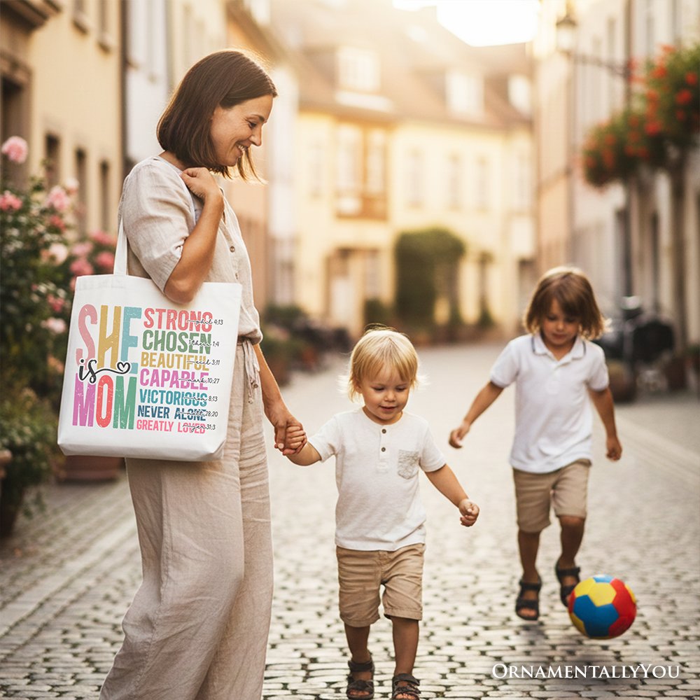 White canvas tote bag with colorful affirmation print and light handles, carried