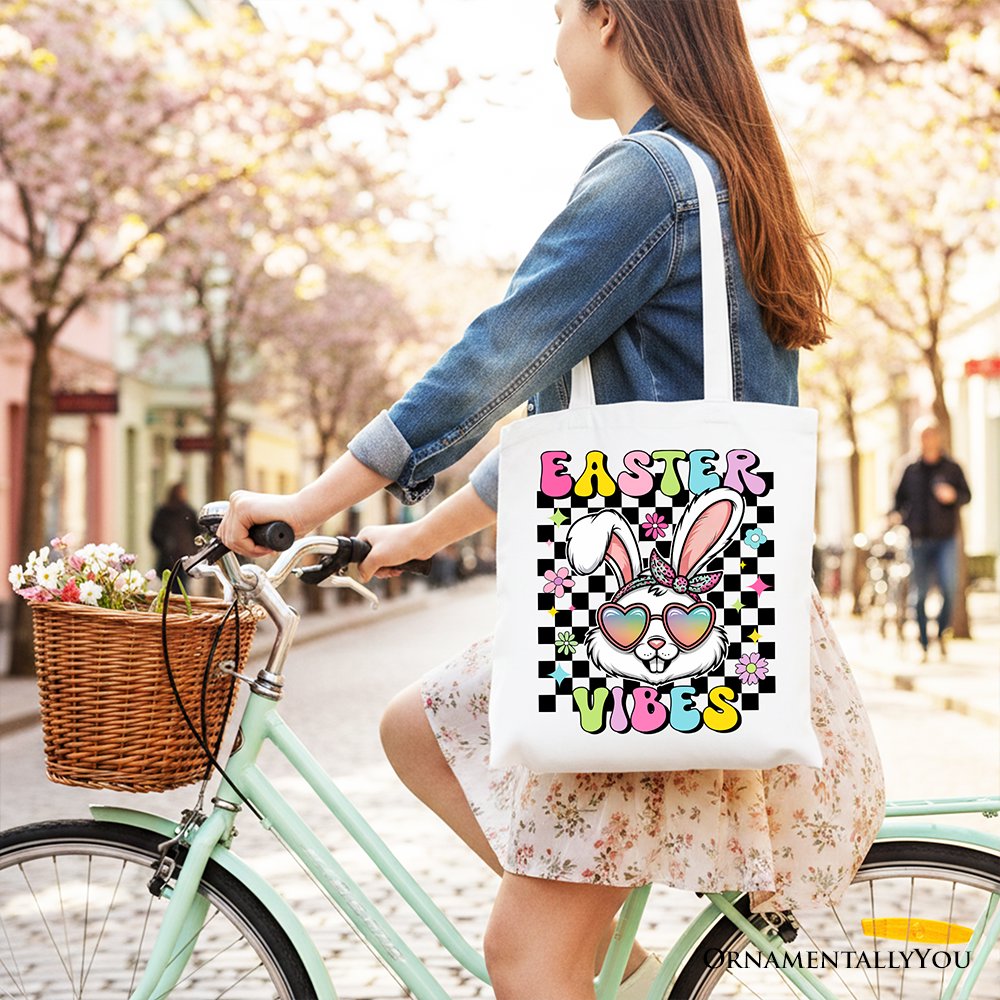 White cotton tote bag with navy handles and 'Easter Vibes' bunny graphic.