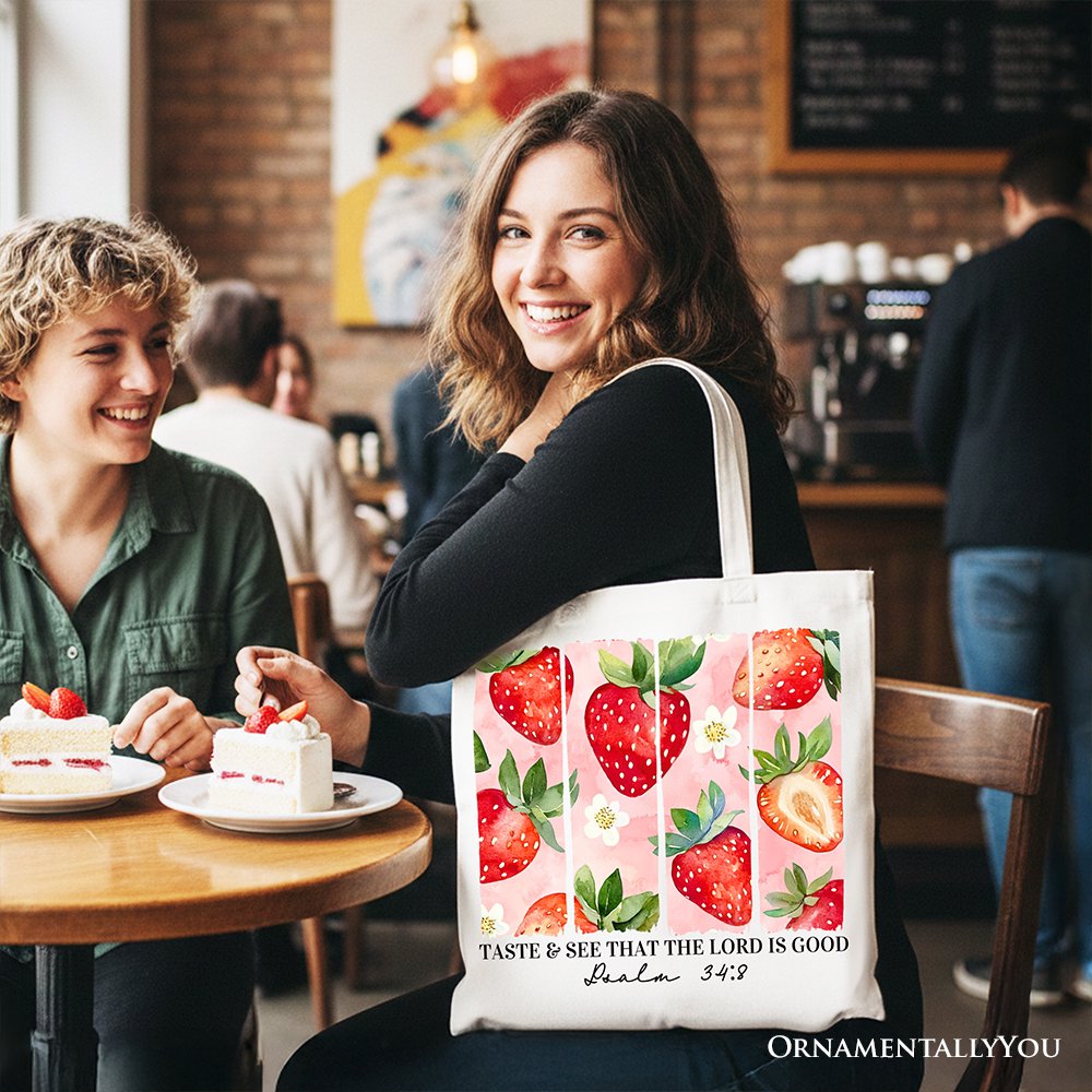 Strawberry print canvas tote bag with dark handles, front graphic and text