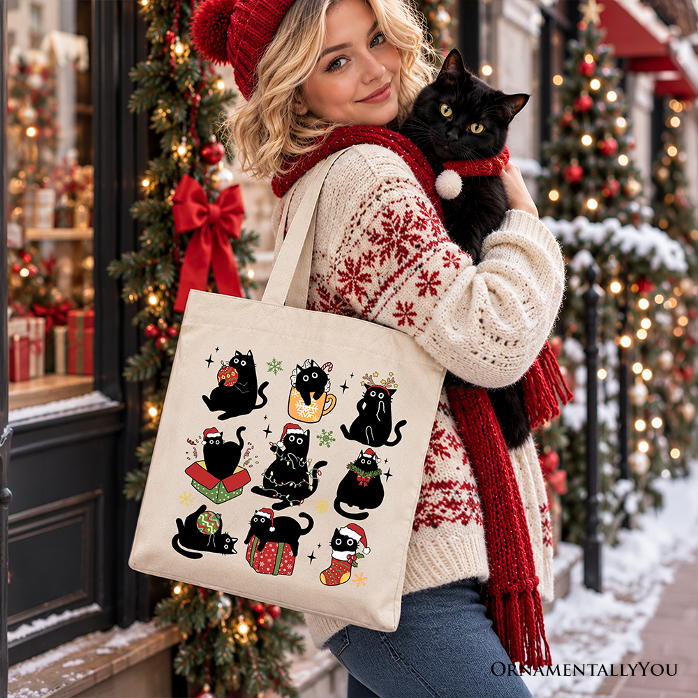 Tote bag with black cat holiday design, Santa hat details, and sturdy top handles