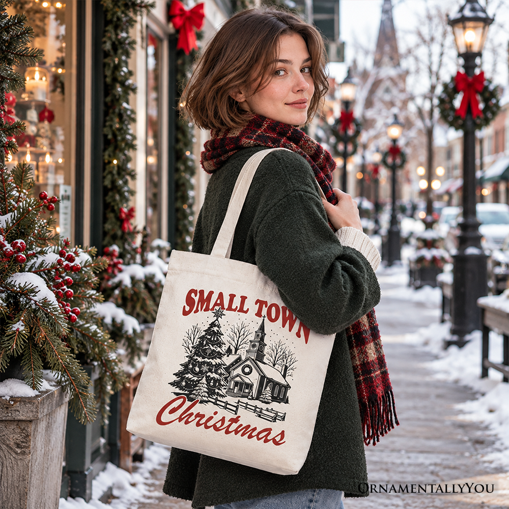 Christmas tote bag on model outdoors; “Small Town Christmas” church and tree design