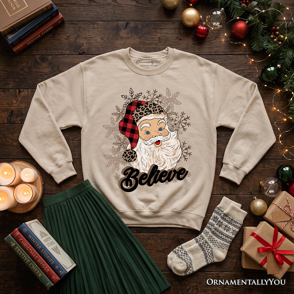 Cream crewneck sweatshirt with Santa face, snowflakes, and 'Believe' print