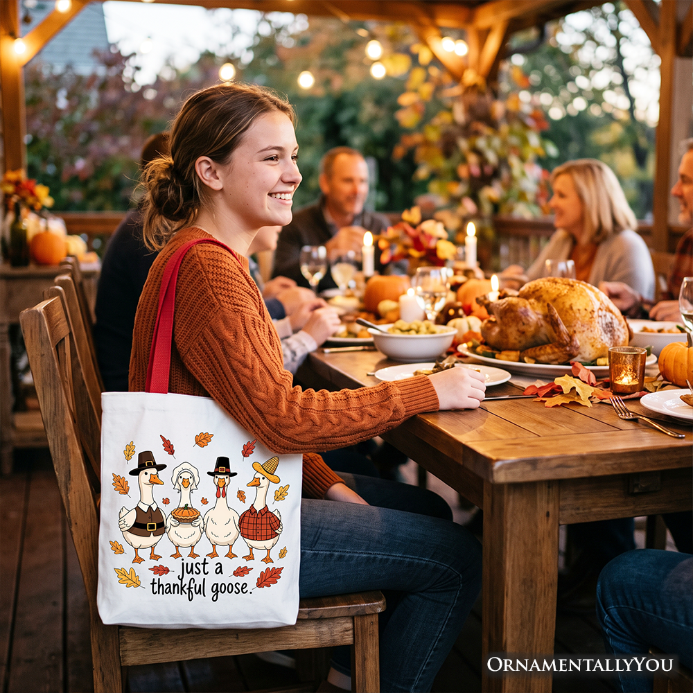 White tote bag with beige handles and turkey family illustration reading 'just a thankful goose'