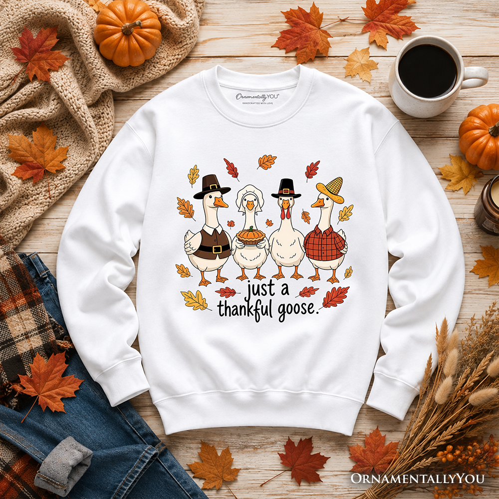 White sweatshirt with cartoon goose and turkey graphic, 'just a thankful goose' text.