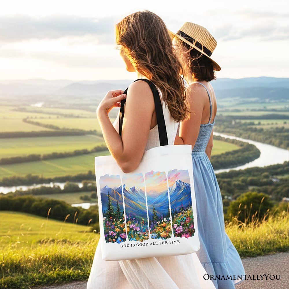 White canvas tote bag with tan handles, mountain landscape bible verse print.