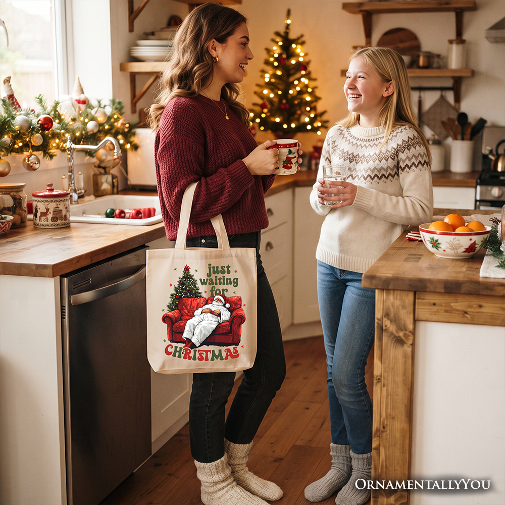 Cream tote bag carried at hip, Santa-on-couch 'Just waiting for Christmas' print