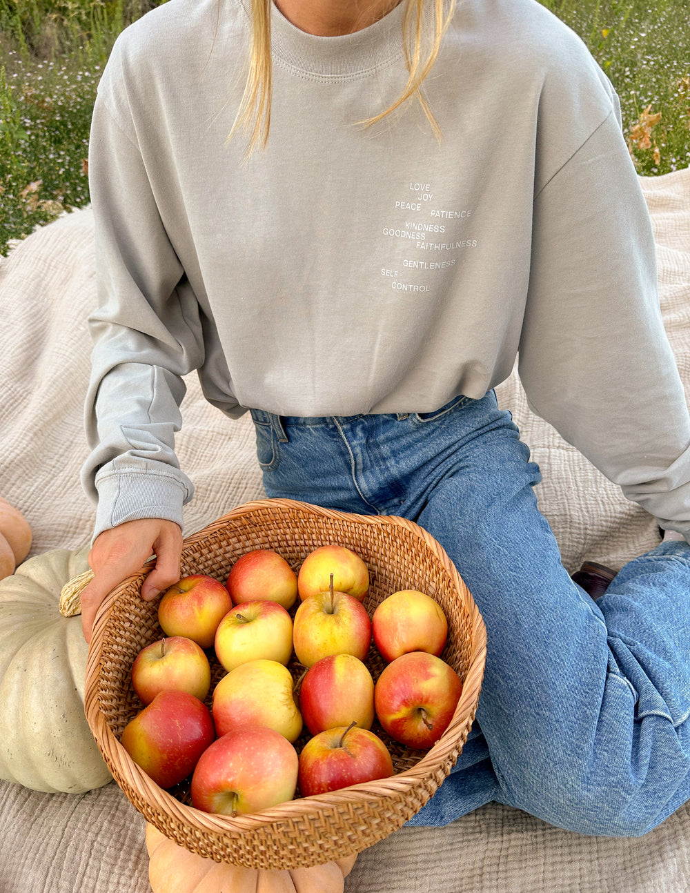 Grey long-sleeve T-shirt with faded inspirational words text near the chest.