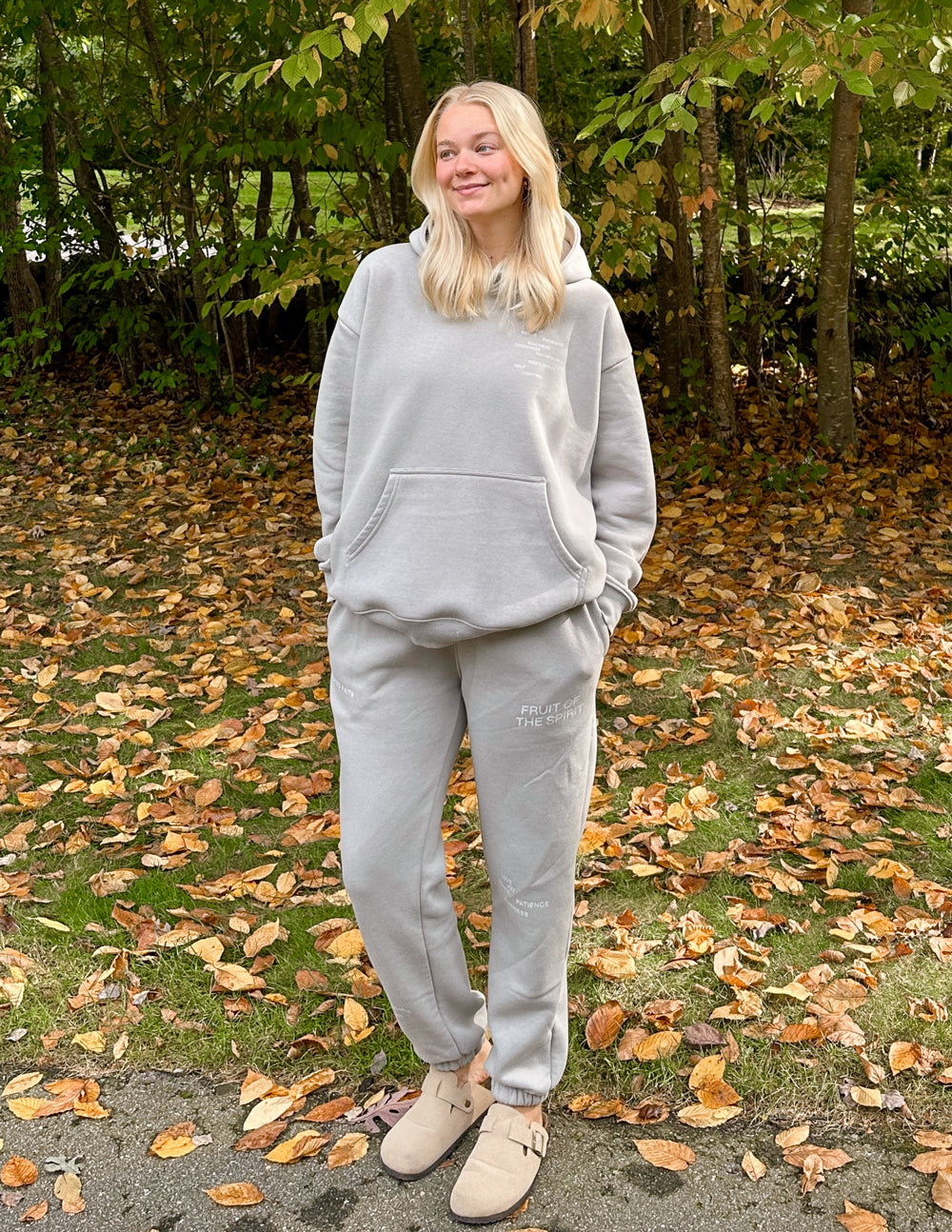 Grey unisex sweatpants with elastic waistband, tapered legs, and cuffed hems